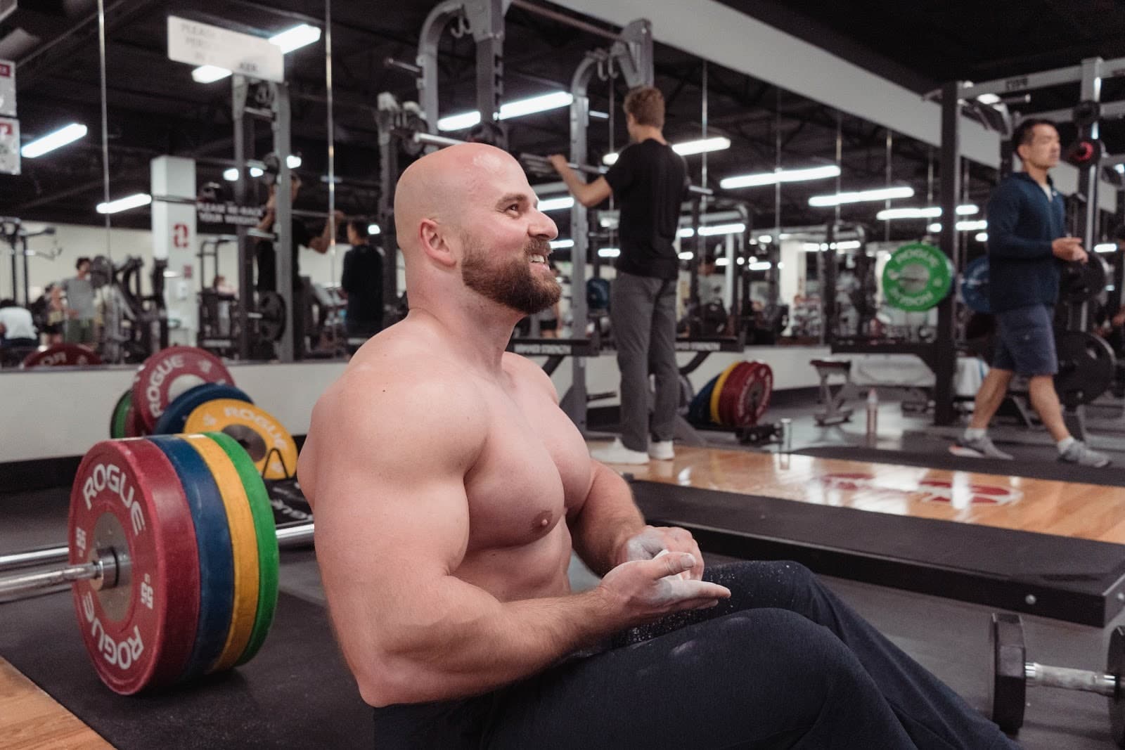Yegor seated in a gym with chalk and weightlifting plates nearby